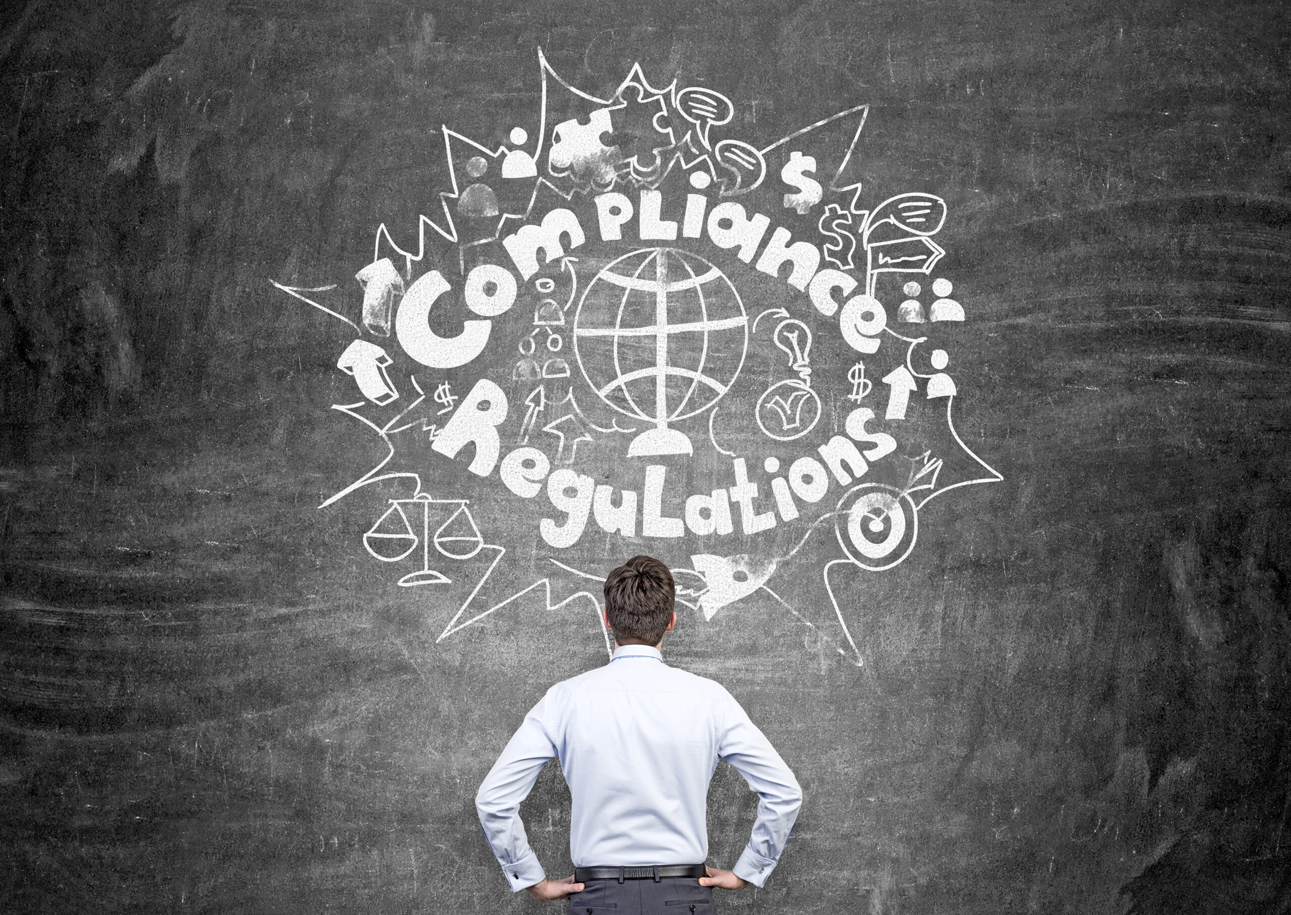 Regulations and compliance concept Regulations and compliance concept with thoughtful businessman looking at chalkboard with sketch